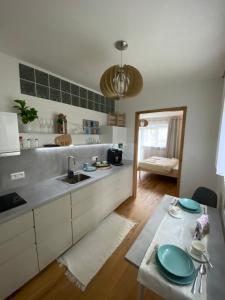 a kitchen with a sink and a table with plates on it at Zeus apartmán in Rajecké Teplice
