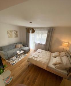 a living room with a bed and a couch at Zeus apartmán in Rajecké Teplice