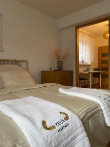 a bedroom with two beds with towels on them at Zeus apartmán in Rajecké Teplice