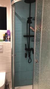 a shower with a glass door in a bathroom at Cozy room in a shared apartment near the See Port Valencia in Valencia