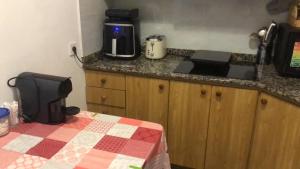 a kitchen with a counter top with a coffee maker on it at Cozy room in a shared apartment near the See Port Valencia in Valencia