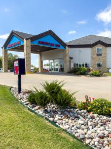 a american inn sign in front of a building at American Inn Madill in Madill