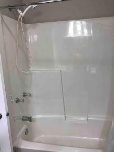 a bathroom with a shower and a bath tub at Hinton Alberta Vacation Home in Hinton +21 photos