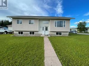 a house with a green lawn in front of it at Hinton Alberta Vacation Home in Hinton