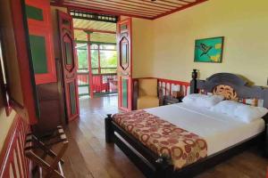 a bedroom with a bed and a room with a door at Finca El Descanso del Duque in La Palmilla