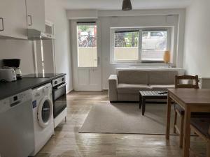 a kitchen and living room with a washer and dryer at Hamburg City Homes in Hamburg