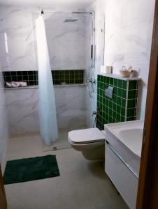a bathroom with a toilet and a tub and a sink at Villa Agate in Midoun