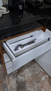 a drawer with a spoon and a sink in it at Casa nova e ventilada, varanda em Praia de Jacaraípe ES in Serra