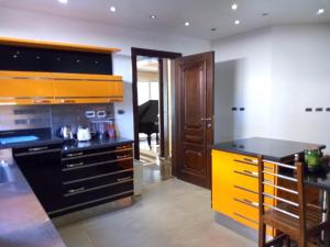 a kitchen with a yellow and black counter top at Heaven new Cairo Villa with Private pool and jacuzzi in Cairo