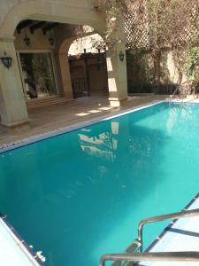 a large swimming pool with blue water at Heaven new Cairo in Cairo