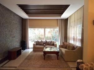 a living room with a couch and a table at Heaven new Cairo Villa with Private pool and jacuzzi in Cairo