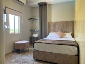 a bedroom with a bed and a window at HOTEl LA CANDELARIA ROOM HOUSE in Mangue