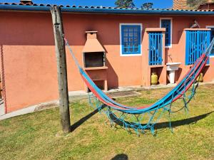 a hammock in a yard in front of a house at Pousada Vale das Araucárias in Santo Antônio do Pinhal
