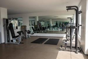 a gym with several tread machines and a large mirror at Luxury Suite 42m2 @ Embassy Gardens Cantonments in Cantonments