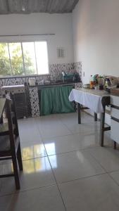 a kitchen with a table and a counter in a room at Sunny Beach in Serra +4 photos