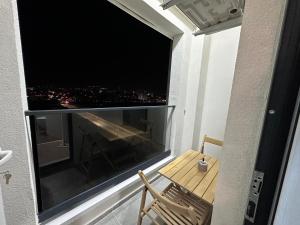 a balcony with a table and a large window at 107 Dreams in Tirana