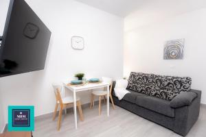 a living room with a couch and a table at Mara 1 Playa del Burrero junto al mar wifi gratis in Ingenio