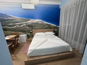 a bedroom with a white bed and a table at 107 Dreams in Tirana