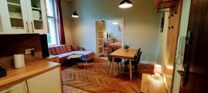 a living room with a couch and a table at Drzewna Apartamenty - Wrocławska in Zielona Góra