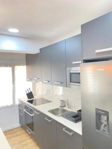 a kitchen with stainless steel appliances and a counter at El portal del románico in Soria