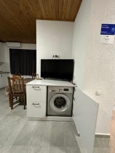 a washing machine with a tv on top of it at Private apartment in Tbilisi City