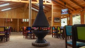a dining room with a fire hydrant and tables and chairs at Hacienda La Lucha in Lucha
