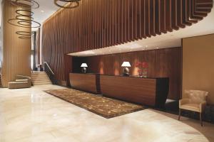 a lobby with a reception desk and a staircase at The Ritz-Carlton, Vienna in Vienna