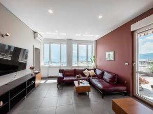 a living room with a couch and a large window at 105m2 Penthouse Sea View Rijeka with FREE GARAGE PARKING in Rijeka