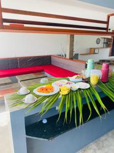 a table with plates of food on top at Vila Kite Lagoon in Parajuru