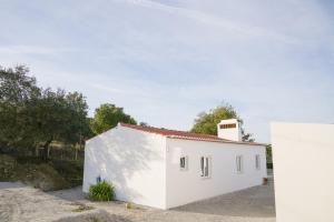 a white building with a chimney on top of it at Quinta do Freixo in Elvas
