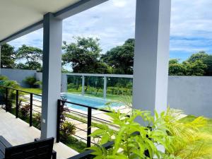 a view from the balcony of a house with a swimming pool at Condominios Akira in Tamarindo