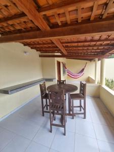 a wooden table and chairs on a patio at Pousada Talismã in Barreirinhas