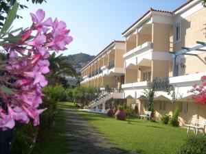 a building with pink flowers in front of it at Paradise Hotel in Samos