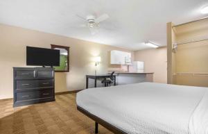 a hotel room with a bed and a flat screen tv at Extended Stay America Suites - New Orleans - Airport in Kenner