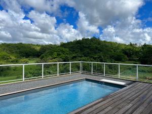 a swimming pool on the deck of a house at Bienvenue à la Villa Ifè in Le Gosier