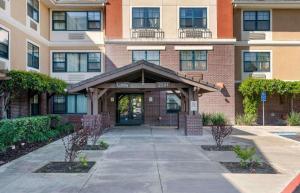 a building with a welcoming entrance to a building at Extended Stay America Suites - Sacramento - Elk Grove in Elk Grove