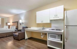 a kitchen with a sink and a refrigerator in a room at Extended Stay America Suites - San Jose - Edenvale - North in San Jose