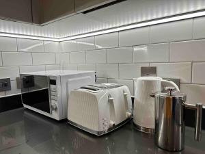 a kitchen counter with a toaster and a toaster at Luxury 2 Bed 2 Bath Central Manchester in Manchester