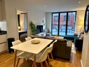 a kitchen and living room with a table and chairs at Luxury 2 Bed 2 Bath Central Manchester in Manchester