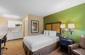 a hotel room with a bed and a kitchen at Extended Stay America Suites - Virginia Beach - Independence Blvd in Virginia Beach