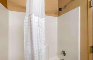 a shower with a white shower curtain in a bathroom at Extended Stay America Suites - Virginia Beach - Independence Blvd in Virginia Beach