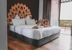 a bedroom with a large bed with a wooden headboard at Magnifiaue appart in Marrakesh