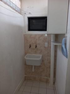 a small bathroom with a sink and a window at La juramento in San Miguel de Tucumán