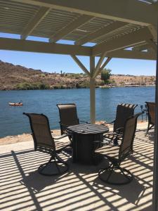 a table and chairs sitting on a deck next to the water at Margaritaville at River Lodge! Right on the river! 