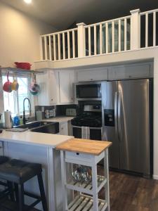 a kitchen with a stainless steel refrigerator and a counter at Margaritaville at River Lodge! Right on the river! in Cross Roads