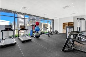 a gym with several treadmills and a balloon in the middle at Beautiful Ocean View Apartment Signature Broadbeach in Gold Coast