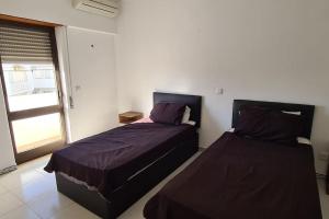 a bedroom with two beds and a window at 403 - Oura - 2 bedroom- Sea View in Albufeira