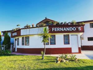 a dog laying in the grass in front of a building at Hotel Fernando´s in Tlalpujahua de Rayón