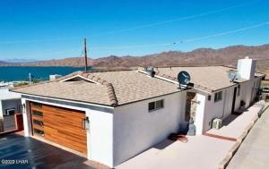 a house with a garage with the view of the water at Million-dollar Lake view on the Parker Strip! in Parker