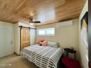 a bedroom with a bed and a wooden ceiling at Million-dollar Lake view on the Parker Strip! in Parker